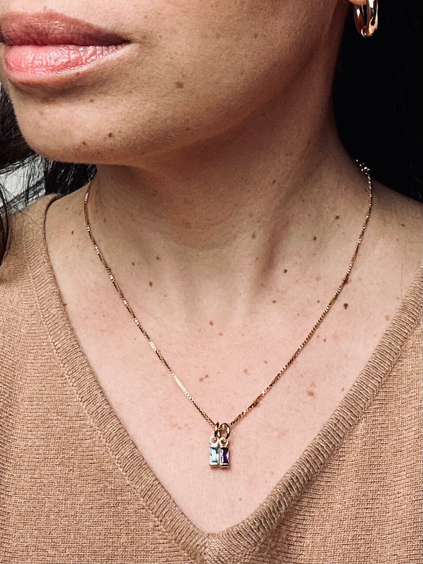 Birthstone necklace featuring two sparkling stones on an 18k gold-filled box chain. The design symbolizes meaningful connections and personal stories, blending elegance with sentimental charm.