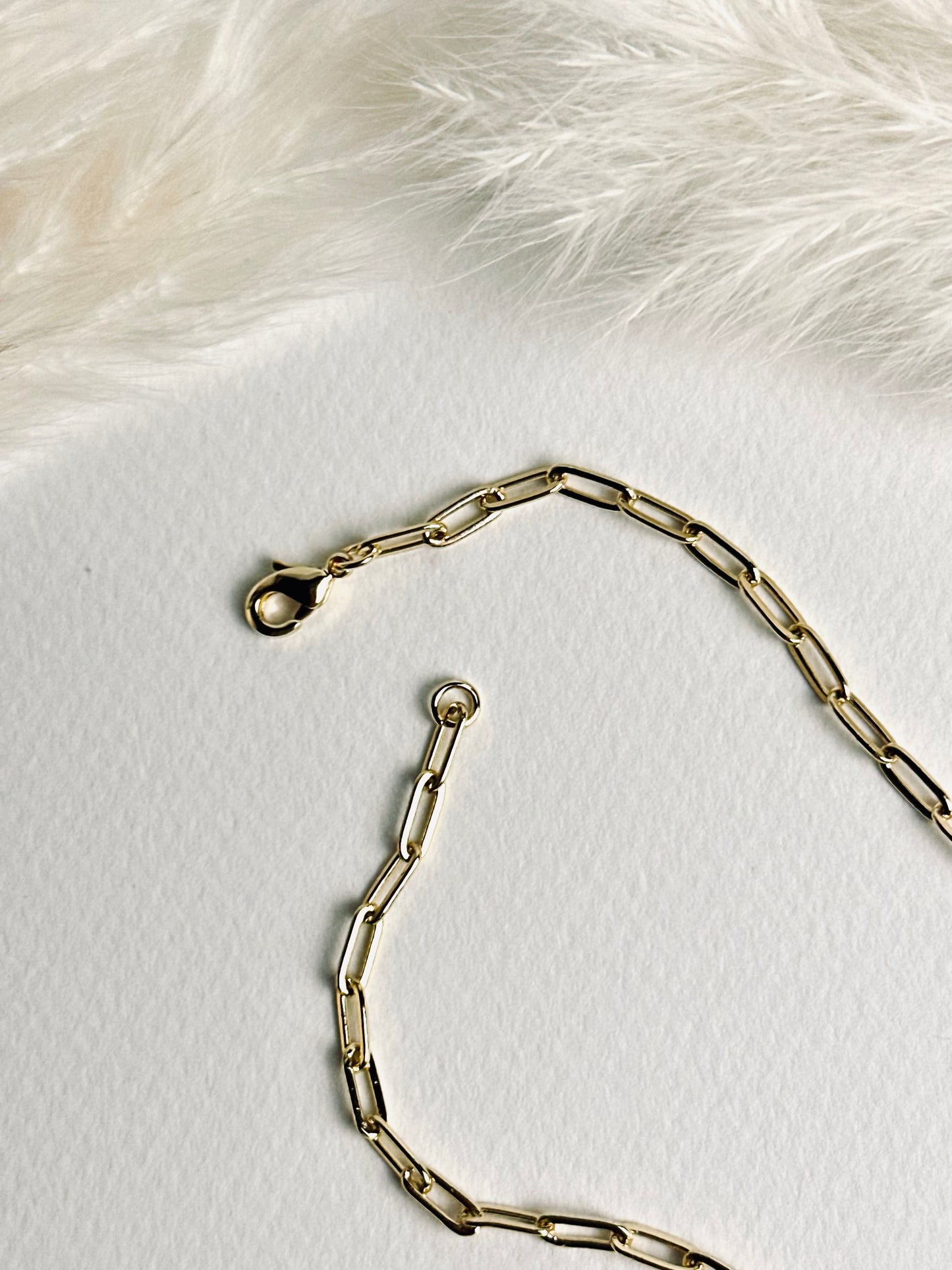 Close-up of the clasp on the personalized clay initial necklace from the “Your Story with Grace” collection, showing the secure 18k gold-filled closure. Highlights thoughtful craftsmanship and elegant, durable design.