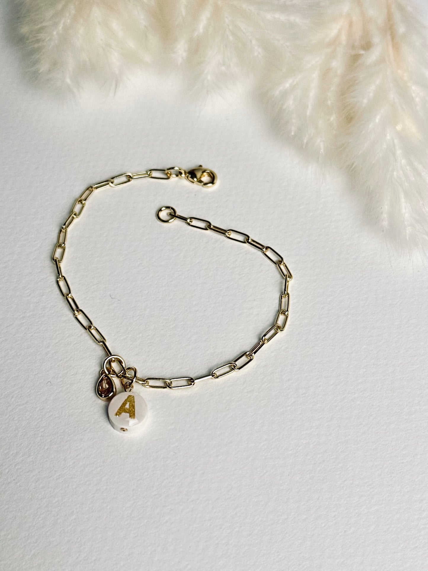 Close-up of the clasp on the personalized clay initial bracelet from the “Your Story with Grace” collection, showing the secure 24k gold-filled closure. The detail highlights craftsmanship, durability, and thoughtful design.