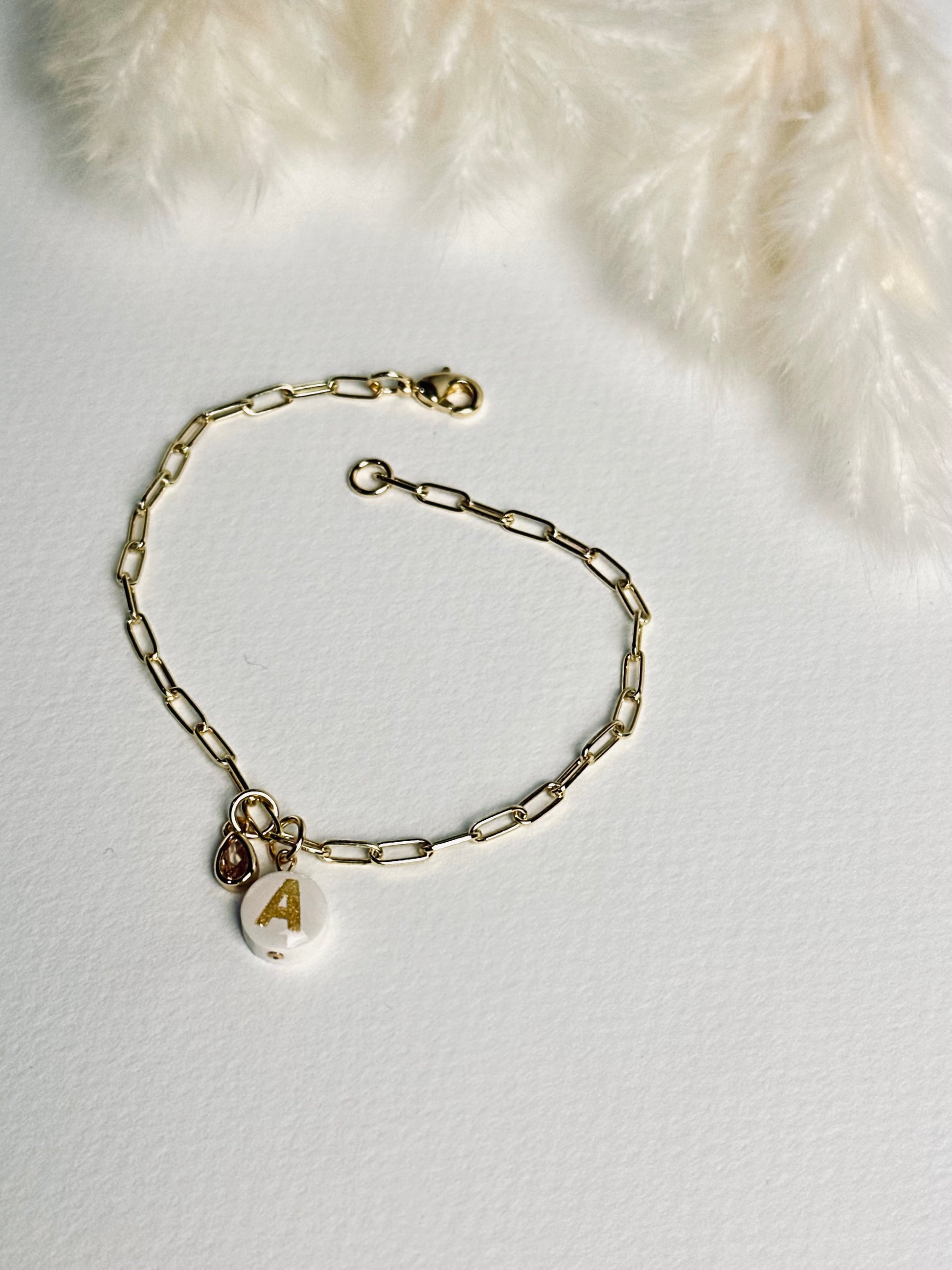 Close-up of the clasp on the personalized clay initial bracelet from the “Your Story with Grace” collection, showing the secure 24k gold-filled closure. The detail highlights craftsmanship, durability, and thoughtful design.