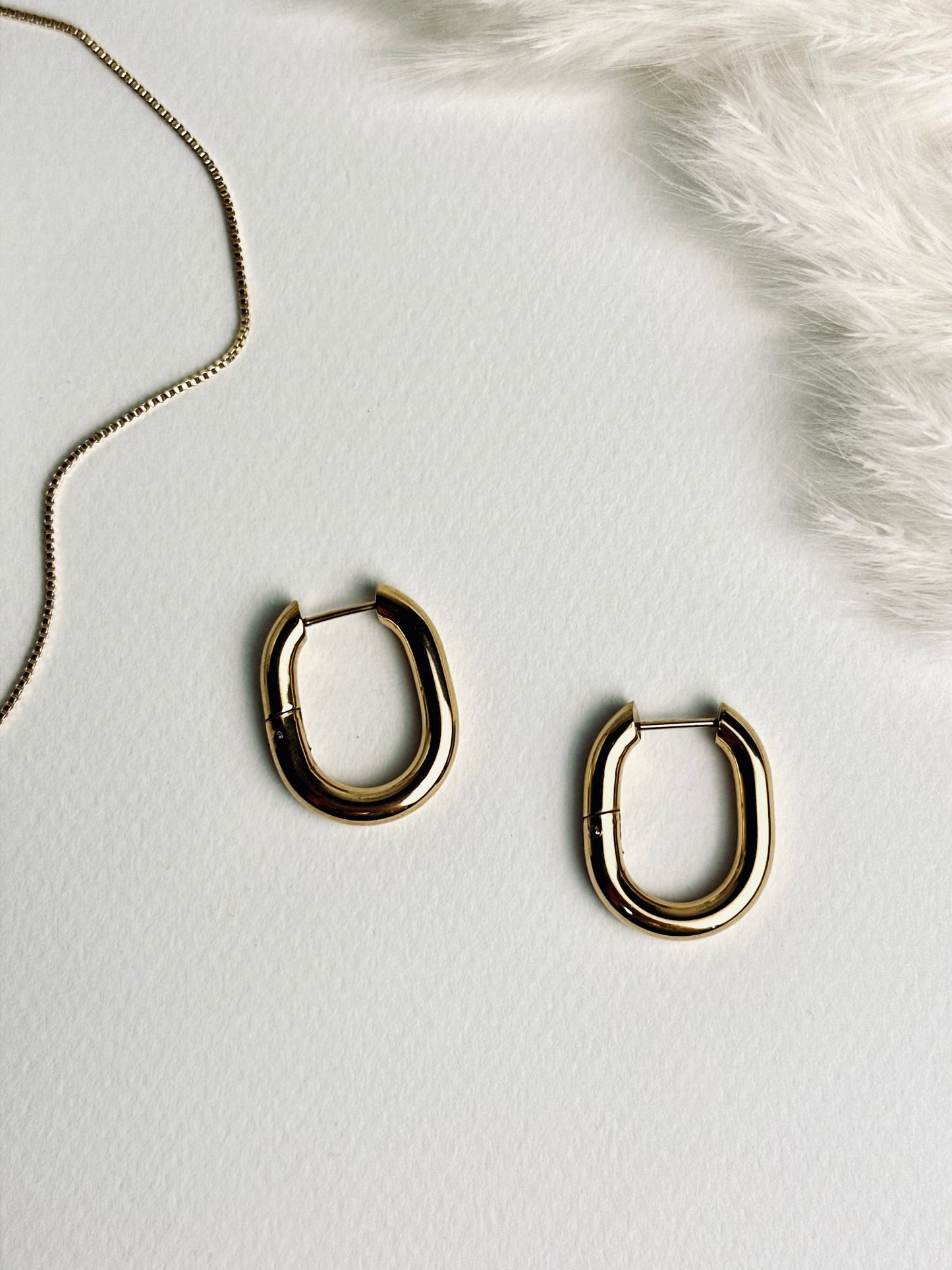 Vera Hoop earrings from the “Timeless Grace” collection paired with a delicate gold box chain necklace. The chunky 18k gold hoops complement the subtle, dainty necklace, creating a layered look that radiates elegance, confidence, and timeless style.