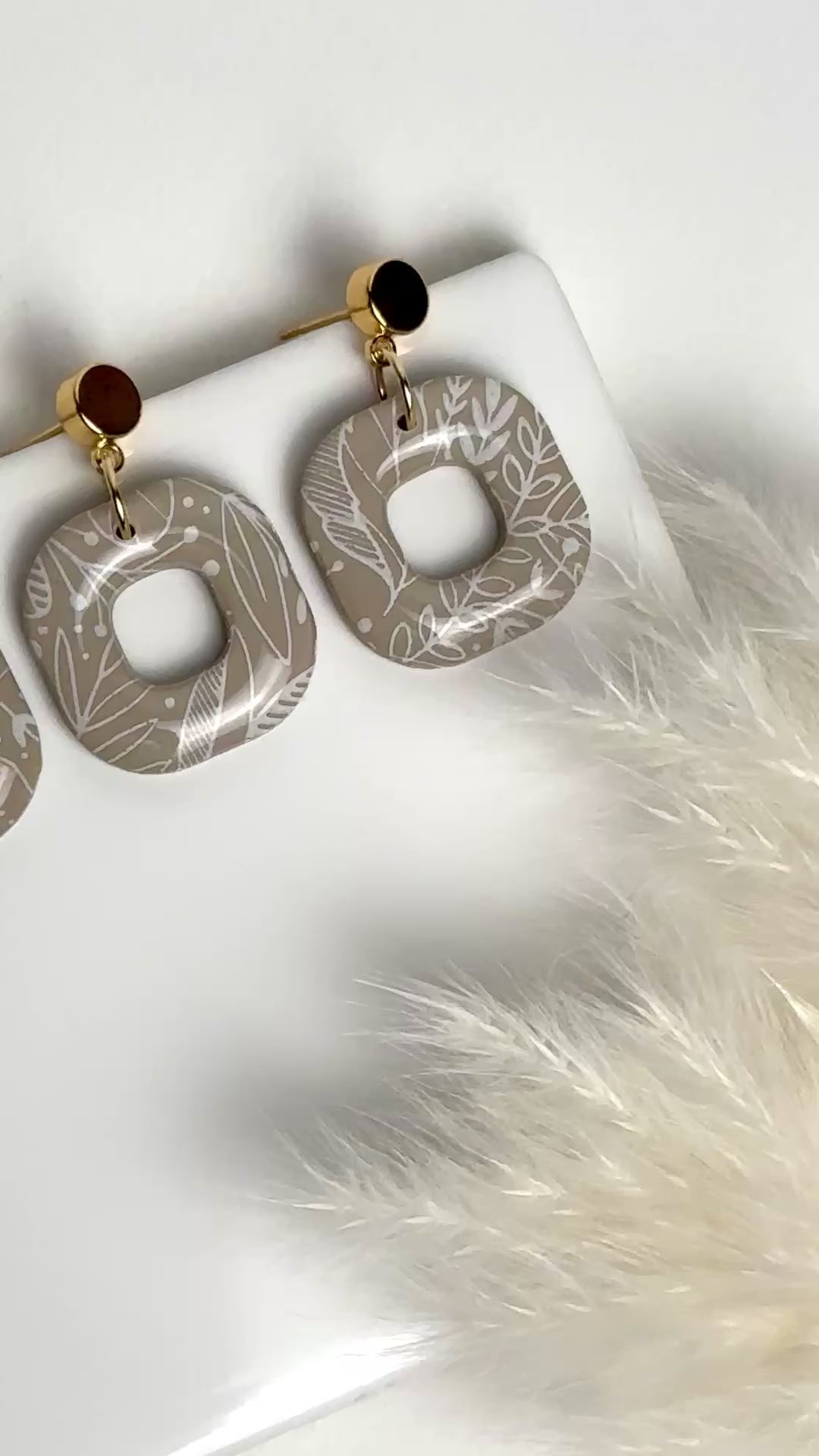 Willow earrings: handmade polymer clay squares in ash brown, with delicate white leaves dancing across the surface, gold plated posts, capturing the gentle movement of a soft breeze.